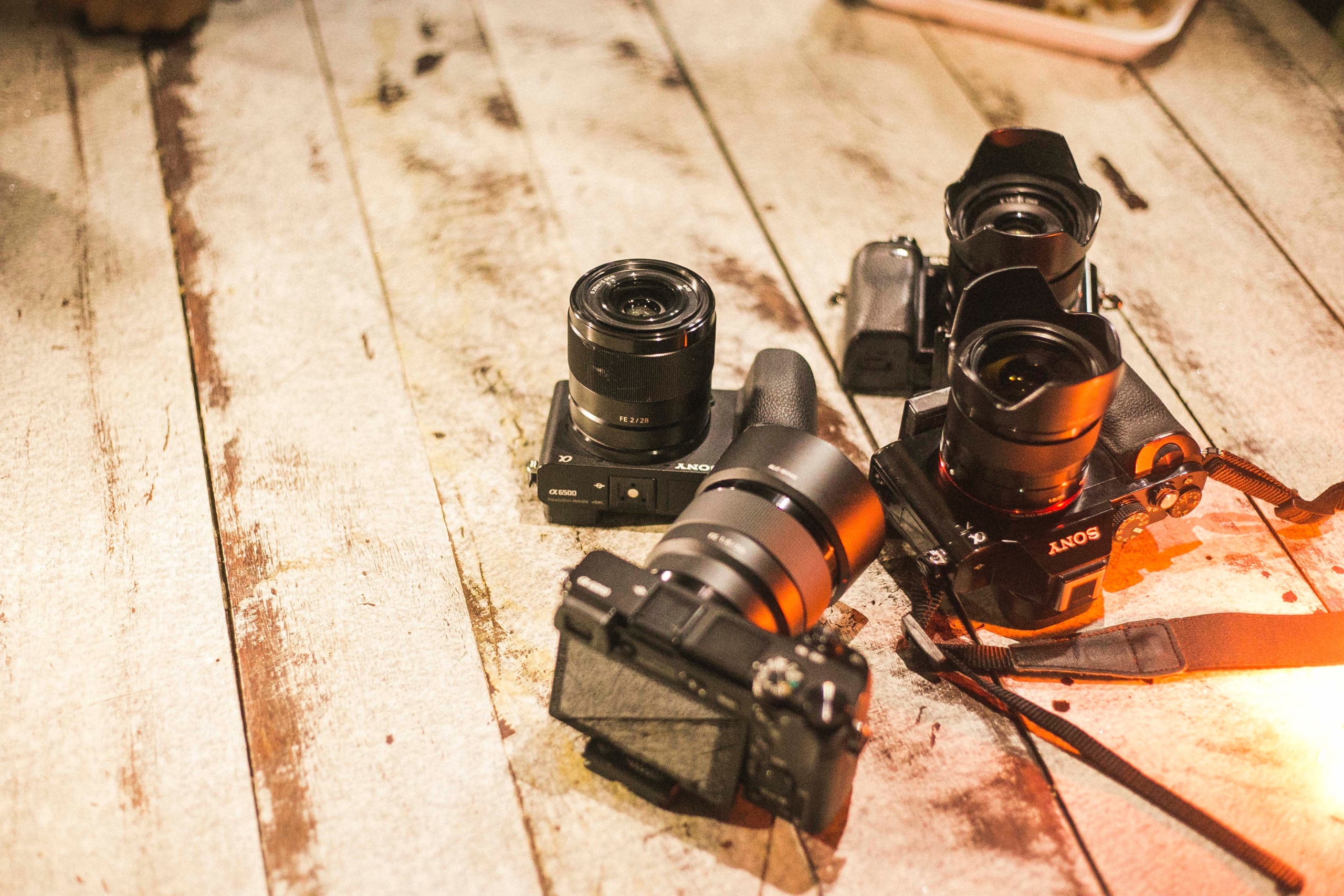 four DSLR cameras on floor